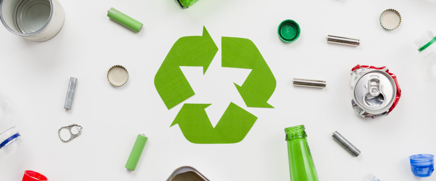 recycling emblem around different trash